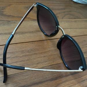 Black sunglasses with gold accents